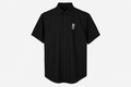 A black short-sleeve button-up shirt with a small white crown and 'M' logo on the left chest, displayed on a clean white background.