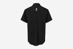 A black short-sleeve button-up shirt shown from the back, featuring a small white crown and 'CC' monogram logo centered on the upper back, set against a plain light gray background.