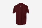 A maroon short-sleeve button-up shirt with a small white crown and 'M' logo on the left chest, displayed on a clean white background.